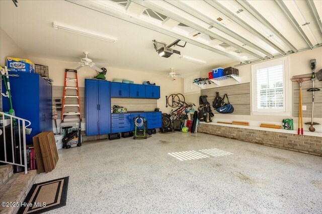 garage with a garage door opener and a ceiling fan