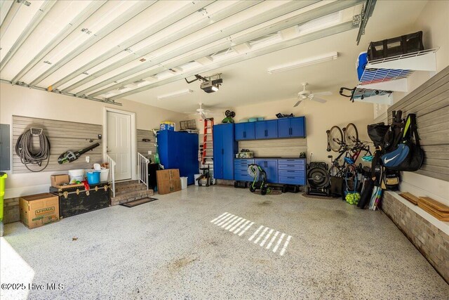 garage with electric panel, a garage door opener, and a ceiling fan