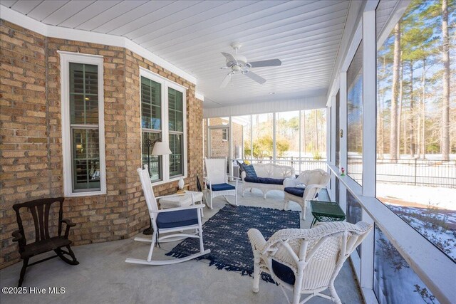 sunroom featuring a ceiling fan