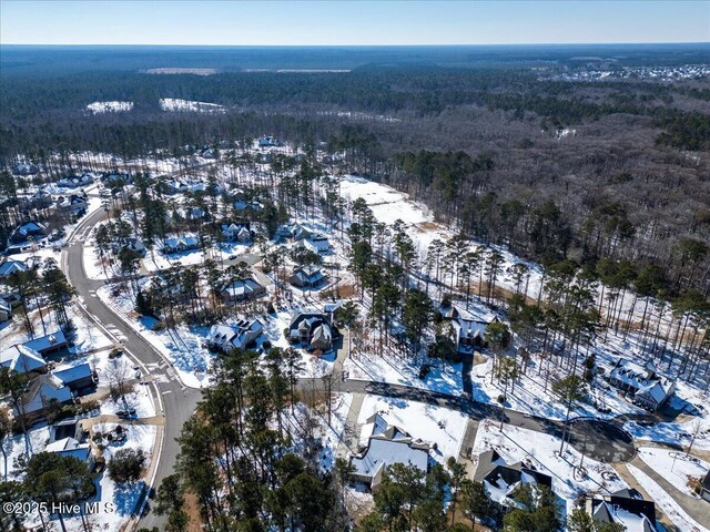 snowy aerial view with a view of trees