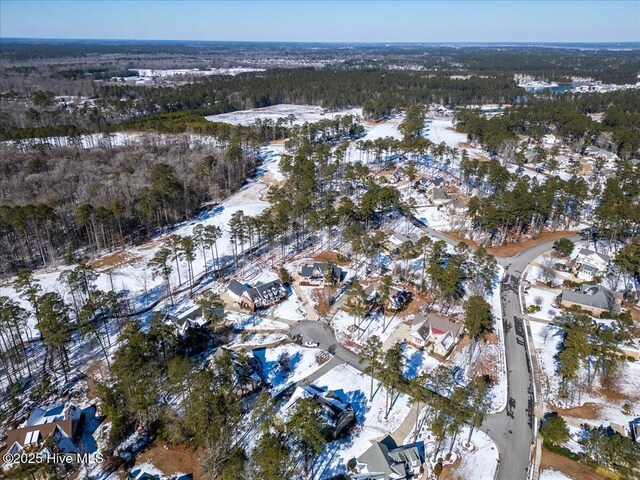 snowy aerial view with a forest view