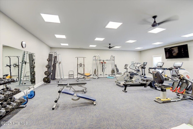 gym featuring baseboards, ceiling fan, and carpet floors