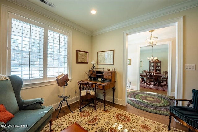 office featuring baseboards, wood finished floors, an inviting chandelier, and ornamental molding