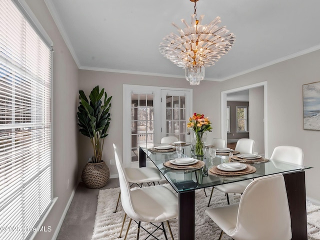 dining space with carpet flooring, a notable chandelier, ornamental molding, and french doors