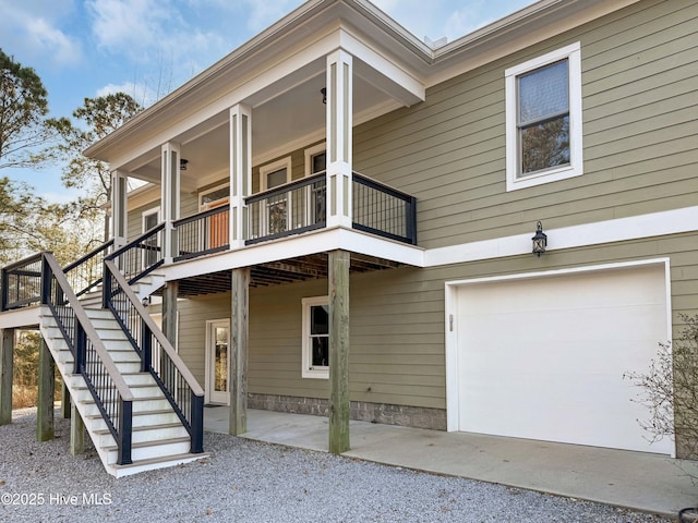 exterior space with a garage and a balcony