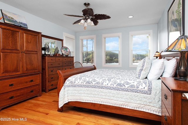 bedroom with ceiling fan and light hardwood / wood-style flooring