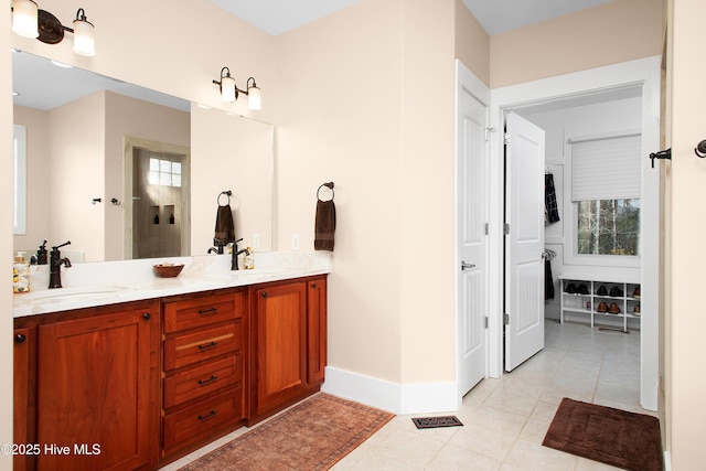 bathroom with plenty of natural light, tile patterned flooring, and vanity