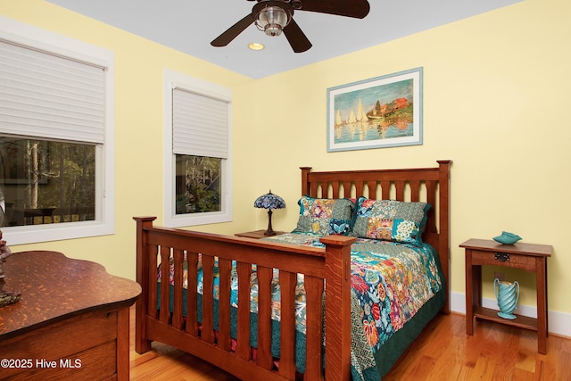 bedroom with ceiling fan and light hardwood / wood-style flooring