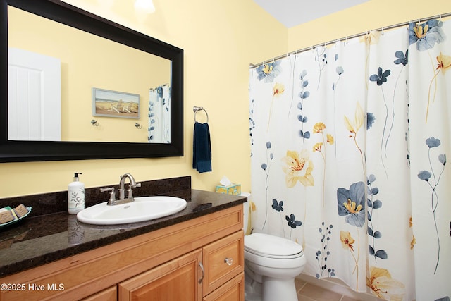 bathroom with tile patterned floors, toilet, vanity, and a shower with curtain