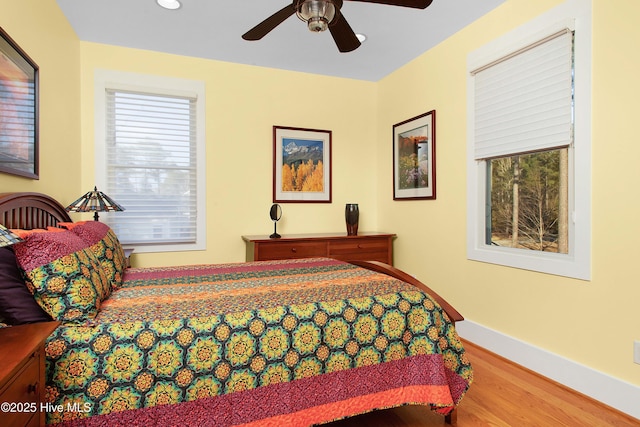 bedroom with wood-type flooring and ceiling fan