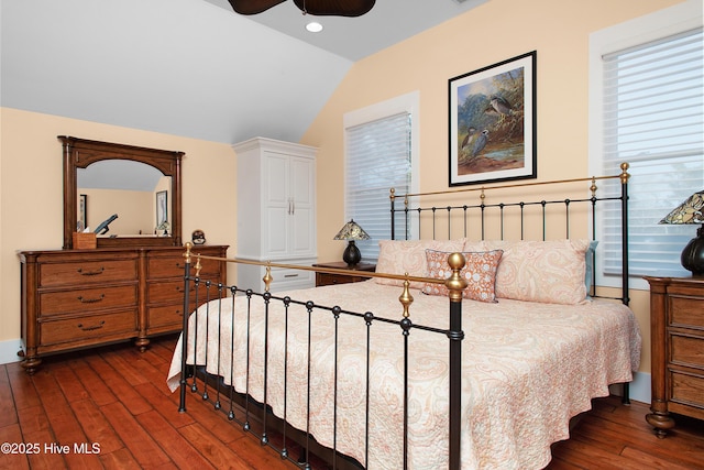 bedroom featuring ceiling fan, dark hardwood / wood-style flooring, and vaulted ceiling