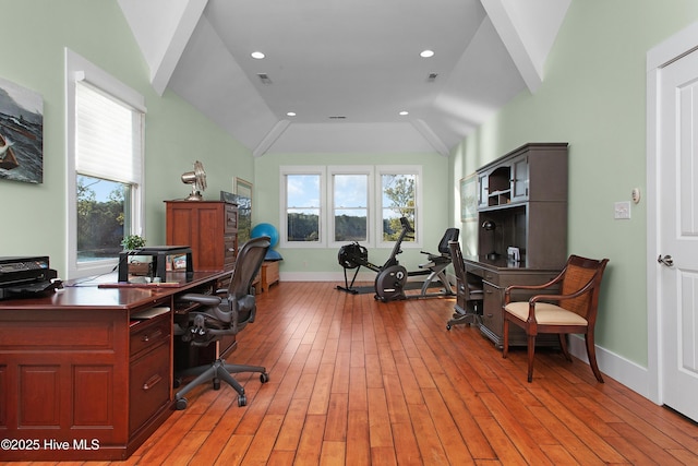 home office featuring vaulted ceiling and light hardwood / wood-style flooring