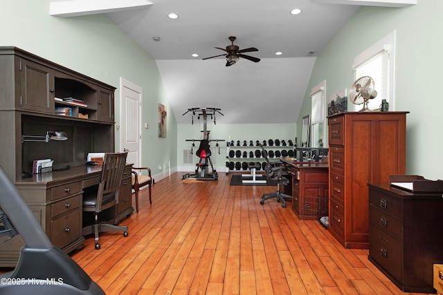 office featuring ceiling fan, light wood-type flooring, and vaulted ceiling