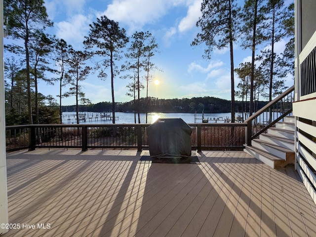 wooden deck with grilling area and a water view