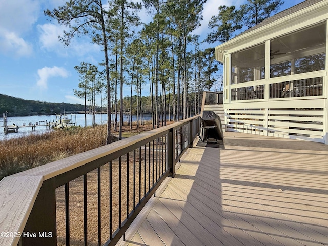 deck with a sunroom and a water view