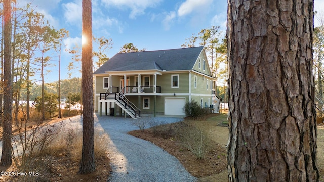 view of front facade with a porch and a garage