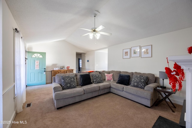 carpeted living room featuring a textured ceiling, vaulted ceiling, and ceiling fan