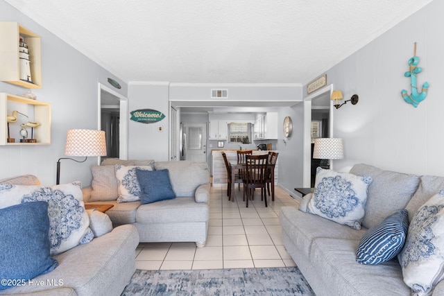 tiled living room with a textured ceiling and crown molding