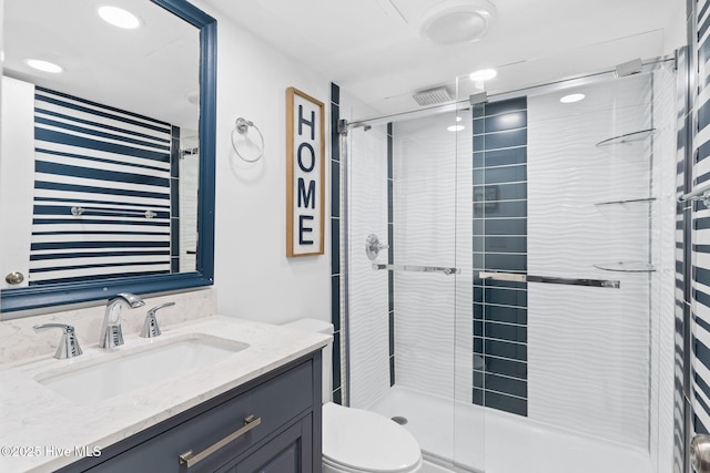 bathroom with vanity, toilet, and an enclosed shower