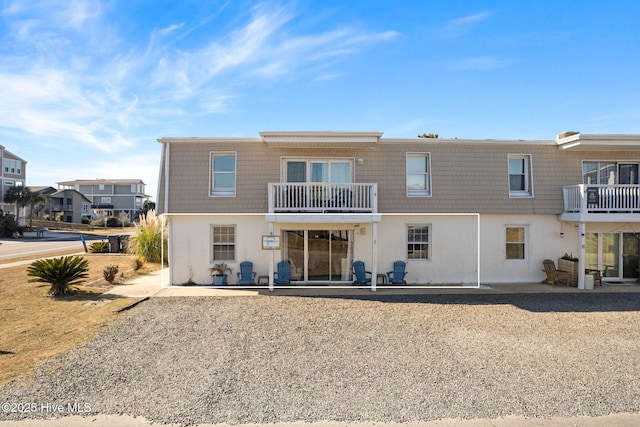 rear view of property featuring a balcony