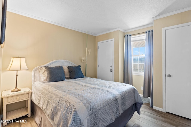 bedroom featuring hardwood / wood-style floors, crown molding, and a textured ceiling