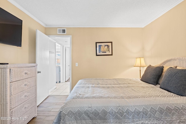 bedroom with a textured ceiling and ornamental molding