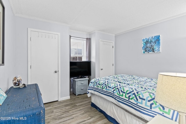 bedroom featuring a closet, ornamental molding, a textured ceiling, and hardwood / wood-style flooring