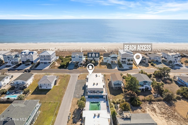 birds eye view of property featuring a beach view and a water view