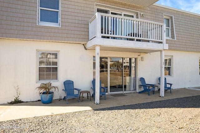 back of house with a balcony and a patio