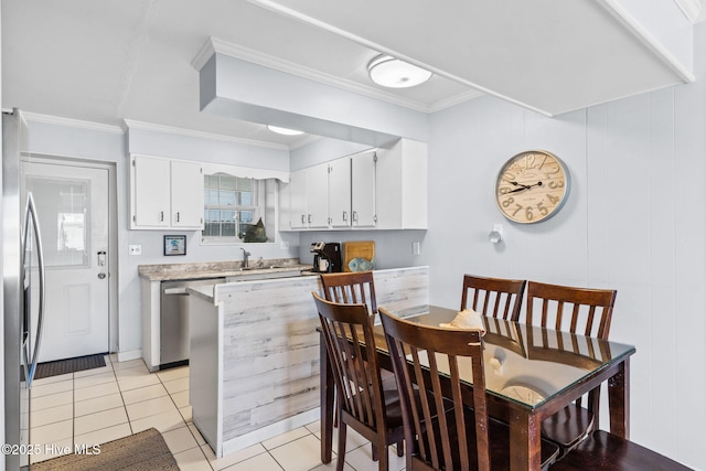 kitchen featuring ornamental molding, stainless steel appliances, sink, white cabinets, and light tile patterned flooring