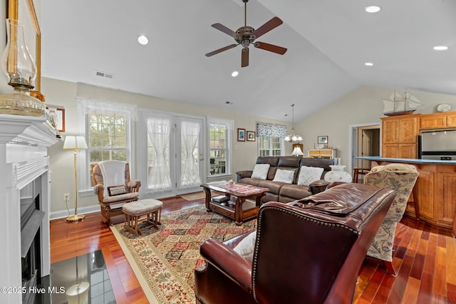 living room with lofted ceiling, dark hardwood / wood-style floors, and ceiling fan