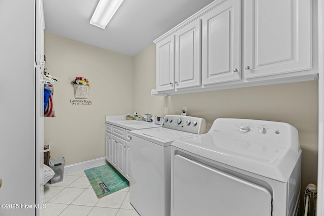 laundry room with sink, independent washer and dryer, light tile patterned floors, and cabinets