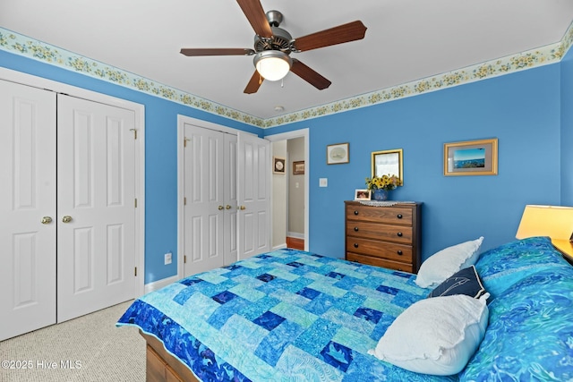 bedroom featuring multiple closets and ceiling fan