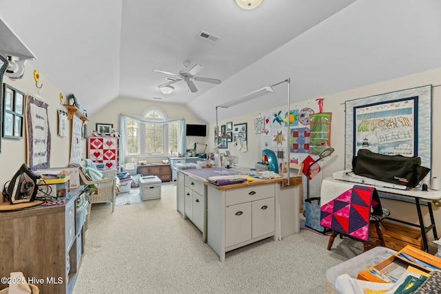 kitchen featuring white cabinetry, light colored carpet, lofted ceiling, and ceiling fan