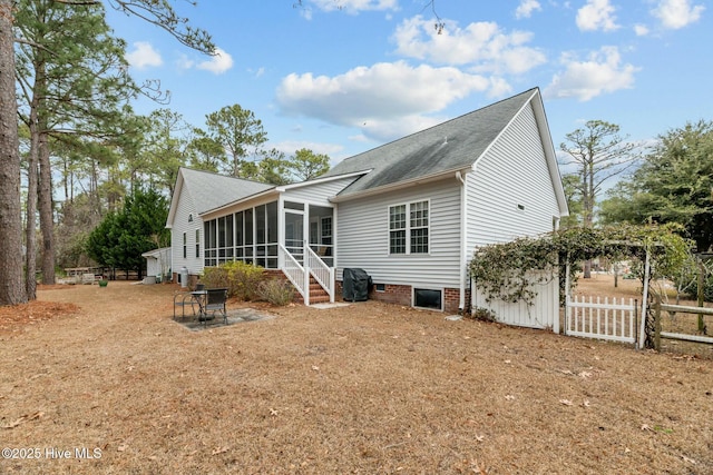 back of house featuring a sunroom