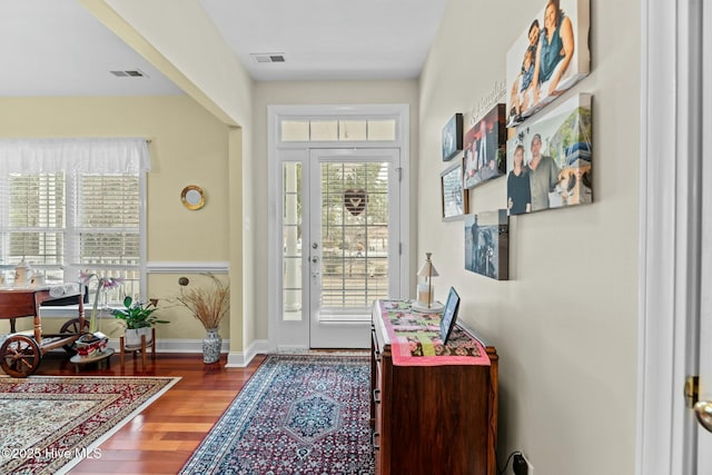 doorway with hardwood / wood-style flooring