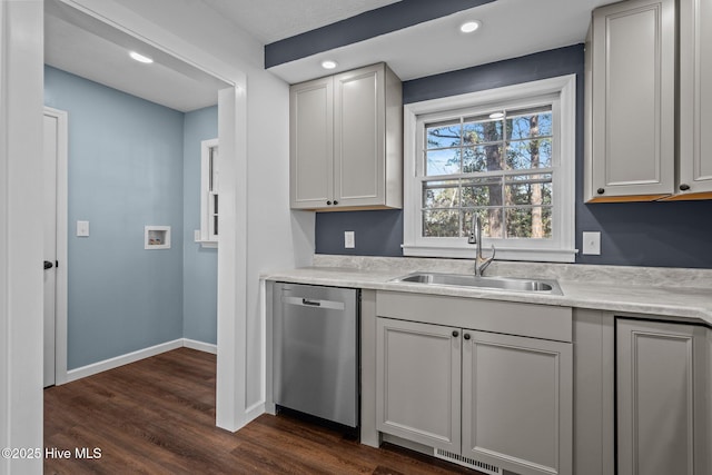 kitchen featuring stainless steel dishwasher, gray cabinetry, sink, and dark wood-type flooring