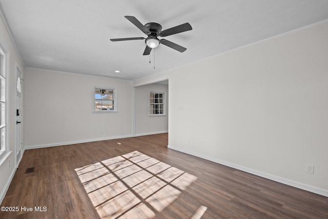 empty room featuring ceiling fan and dark hardwood / wood-style flooring