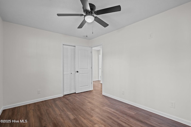 unfurnished bedroom with a closet, ceiling fan, and dark hardwood / wood-style flooring