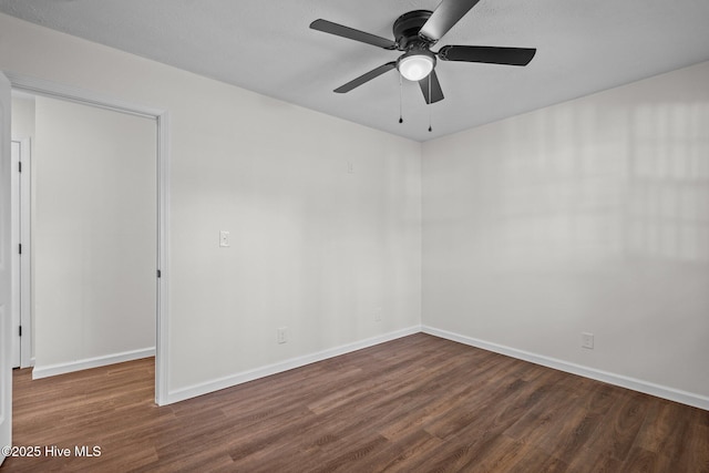 empty room featuring ceiling fan and dark hardwood / wood-style flooring