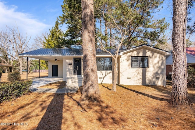 ranch-style home with a carport and ceiling fan