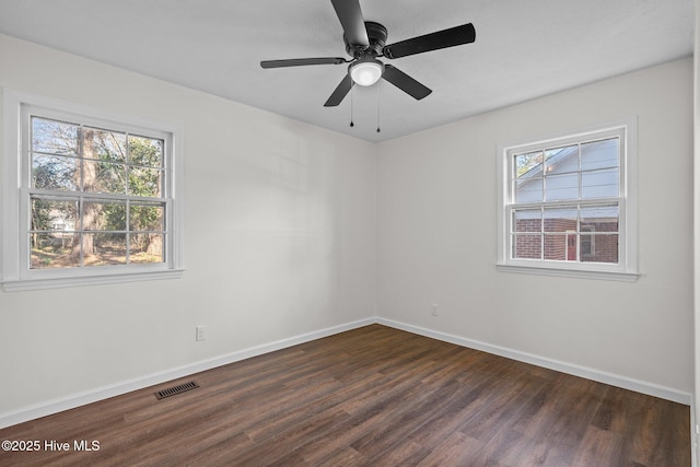 unfurnished room with dark hardwood / wood-style flooring, ceiling fan, and a healthy amount of sunlight