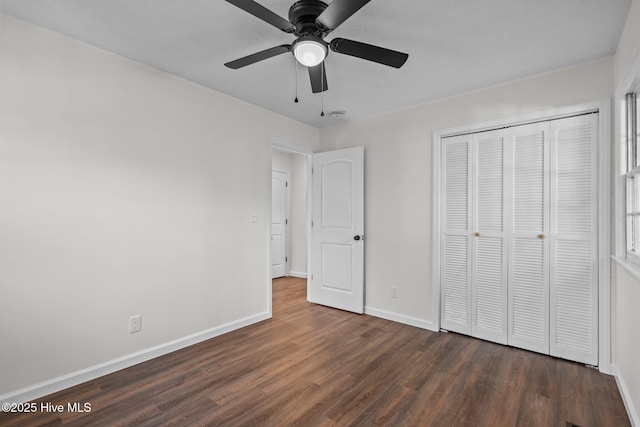 unfurnished bedroom featuring ceiling fan, dark hardwood / wood-style flooring, and a closet