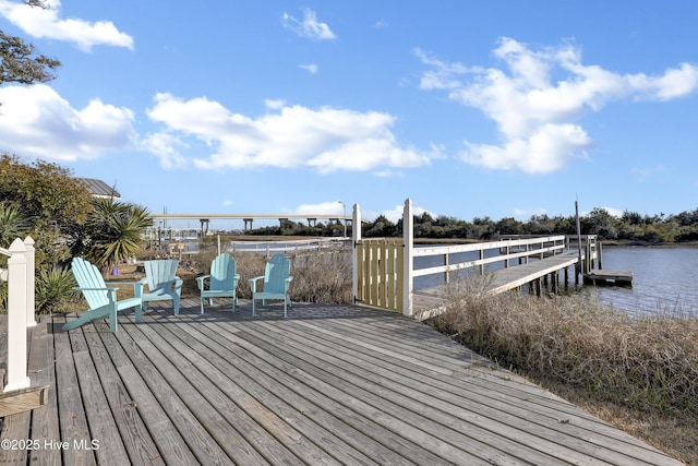 wooden terrace with a dock and a water view