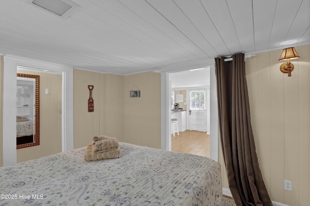 unfurnished bedroom with wood ceiling and wood walls