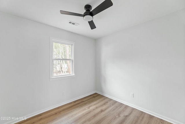 empty room with ceiling fan and light hardwood / wood-style flooring