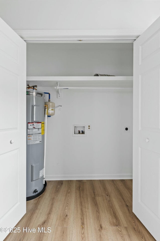 washroom featuring washer hookup, electric water heater, hardwood / wood-style flooring, and electric dryer hookup