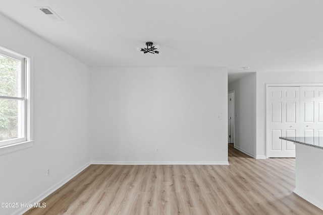 empty room with light hardwood / wood-style floors