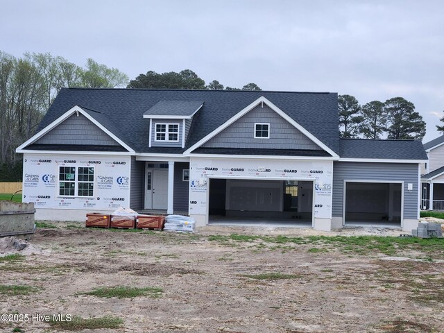 craftsman house with a front yard and a garage