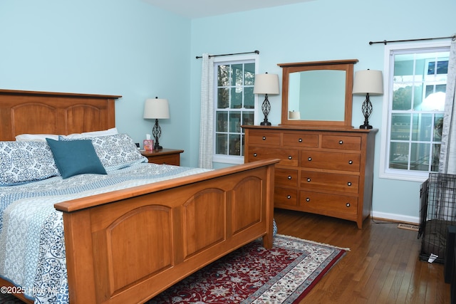 bedroom with dark hardwood / wood-style floors